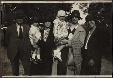 Foto di gruppo: due donne con bambini in braccio, una ragazza e un uomo